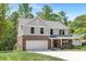 Beautiful exterior view of a home featuring a brick facade, gray siding and attached garage at 8937 Penstemons Dr, Charlotte, NC 28215