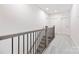 Hallway with carpet, a banister, and white trim and doors at 8937 Penstemons Dr, Charlotte, NC 28215