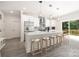 Modern kitchen featuring stainless steel appliances, a central island with seating, and a sliding glass door at 8937 Penstemons Dr, Charlotte, NC 28215
