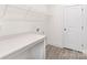 Functional laundry room featuring a countertop, modern flooring, and a crisp, clean design at 8937 Penstemons Dr, Charlotte, NC 28215