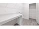 Bright laundry room with folding counter and ample shelving at 8937 Penstemons Dr, Charlotte, NC 28215