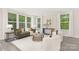 Bright and airy living room with large windows, neutral décor, and stylish modern furniture at 8937 Penstemons Dr, Charlotte, NC 28215
