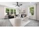 Cozy living room featuring a black fan and plush seating with bright, natural light at 8937 Penstemons Dr, Charlotte, NC 28215
