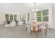 Open-concept living room and dining area with lots of natural light and modern finishes at 8937 Penstemons Dr, Charlotte, NC 28215
