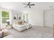 Large main bedroom with carpet floors, lots of light, and a tray ceiling at 8937 Penstemons Dr, Charlotte, NC 28215