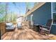 Inviting deck with rocking chairs and cozy seating, overlooking trees and the exterior of the home at 912 Westside Dr, Newton, NC 28658