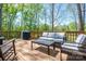 Cozy back deck with ample seating, a grill, and a wooded view, perfect for relaxation at 912 Westside Dr, Newton, NC 28658