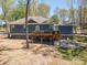 Landscaped backyard featuring a charming fire pit and deck at 912 Westside Dr, Newton, NC 28658