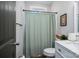 Cozy bathroom featuring a marble countertop, framed mirror, and a shower with light green shower curtain at 912 Westside Dr, Newton, NC 28658