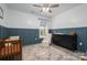 Comfortable Bedroom with a wooden crib, dark dresser, and rocking chair with half-wall paneling at 912 Westside Dr, Newton, NC 28658