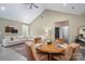 Open dining and living area with vaulted ceiling, light colored sofa and area rug at 912 Westside Dr, Newton, NC 28658