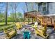 Outdoor fire pit encircled by colorful Adirondack chairs, backing onto elevated deck and grassy expanse at 912 Westside Dr, Newton, NC 28658