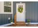 Close-up of the front door with a wreath, number 912, and potted plants on either side at 912 Westside Dr, Newton, NC 28658