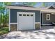 Close up of one car garage door and stone details on a home's exterior at 912 Westside Dr, Newton, NC 28658
