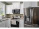 Modern kitchen with stainless steel appliances, granite countertops and ample cabinet space at 912 Westside Dr, Newton, NC 28658