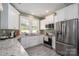 Well-lit kitchen showcasing stainless steel appliances, granite counters, and white cabinetry at 912 Westside Dr, Newton, NC 28658