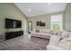 Comfortable living room with a sectional sofa, TV and access to an outdoor deck at 912 Westside Dr, Newton, NC 28658