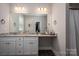 Main bathroom with double vanity, granite countertops, and walk-in closet access at 912 Westside Dr, Newton, NC 28658