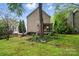 Spacious backyard with a charming screened-in porch, mature trees, and lush landscaping at 9209 Rotherham Ln, Charlotte, NC 28216
