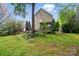 Beautiful backyard featuring a screened-in porch and mature trees at 9209 Rotherham Ln, Charlotte, NC 28216