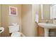 Cozy half bathroom featuring elegant pedestal sink, modern fixtures, and stylish décor for a welcoming space at 9209 Rotherham Ln, Charlotte, NC 28216