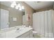 Bathroom with a white vanity, large mirror, and shower with curtain at 9209 Rotherham Ln, Charlotte, NC 28216