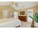 Spacious bedroom with hardwood floors, a ceiling fan, and a view of the bathroom at 9209 Rotherham Ln, Charlotte, NC 28216