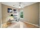Minimal bedroom features a fish tank, a window, hardwood floors, and a ceiling fan at 9209 Rotherham Ln, Charlotte, NC 28216