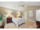 Bright bedroom with hardwood floors, lamps, and a ceiling fan at 9209 Rotherham Ln, Charlotte, NC 28216