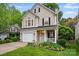 Charming two-story home with inviting front porch and well-maintained lawn with landscaped flower bed at 9209 Rotherham Ln, Charlotte, NC 28216