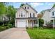 Charming two-story home with inviting front porch and well-maintained lawn with landscaped flower bed at 9209 Rotherham Ln, Charlotte, NC 28216