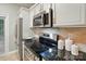 Modern kitchen featuring stainless steel appliances, granite countertops, and sleek cabinetry for a sophisticated design at 9209 Rotherham Ln, Charlotte, NC 28216