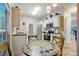 Bright, updated kitchen features stainless steel appliances, granite countertops, and tile floors with a breakfast table at 9209 Rotherham Ln, Charlotte, NC 28216