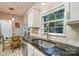 Granite countertop with stainless steel sink, enhanced by modern fixtures and natural light from nearby windows at 9209 Rotherham Ln, Charlotte, NC 28216