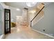 Open-concept living room with hardwood floors, staircase and vaulted ceiling, creating an inviting and spacious atmosphere at 9209 Rotherham Ln, Charlotte, NC 28216