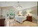 Bright, airy bedroom with vaulted ceilings, hardwood floors, and lots of natural light from the windows at 9209 Rotherham Ln, Charlotte, NC 28216