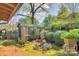 View of a backyard featuring a shed and ornate landscaping with gravel and grass at 1000 E 35Th St, Charlotte, NC 28205