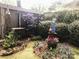 View of a backyard featuring a shed and ornate landscaping with gravel and grass at 1000 E 35Th St, Charlotte, NC 28205