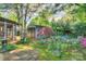 Secluded backyard with lush trees, a shed, and a brick pathway at 1000 E 35Th St, Charlotte, NC 28205