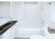 Compact bathroom with white tiles, black countertops, and chrome finishes, a functional and neatly designed space at 1000 E 35Th St, Charlotte, NC 28205
