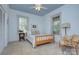 Bright bedroom with a ceiling fan, neutral walls, carpeted floors, and dual pane windows, creating a cozy atmosphere at 1000 E 35Th St, Charlotte, NC 28205