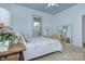 Bright bedroom featuring a bed, large mirror, and window letting in natural light at 1000 E 35Th St, Charlotte, NC 28205