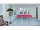 Sunlit dining room with large windows, a table with a pink tablecloth, and a chair at 1000 E 35Th St, Charlotte, NC 28205