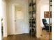 Unique hallway with a 'Dr. Vista' door, metal shelving, hardwood floors and view to a lounge room at 1000 E 35Th St, Charlotte, NC 28205