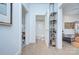 Bright hallway with a 'Wash Your Hands' bathroom door, metal shelving, hardwood floors and view to a lounge room at 1000 E 35Th St, Charlotte, NC 28205