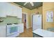 Charming kitchen with white cabinets, a vintage-style stove, and colorful decor, creating a cozy and inviting cooking space at 1000 E 35Th St, Charlotte, NC 28205