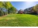 Spacious backyard with lush green grass and mature trees next to golf course at 105 Snead Ct, Salisbury, NC 28144
