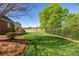 Expansive backyard featuring lush green lawn and mature trees with golf course view at 105 Snead Ct, Salisbury, NC 28144