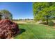 Beautiful backyard with lush green grass and view of the golf course in the distance at 105 Snead Ct, Salisbury, NC 28144