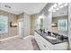 Bright bathroom with a double vanity, granite counters, decorative wallpaper and a glass shower at 105 Snead Ct, Salisbury, NC 28144